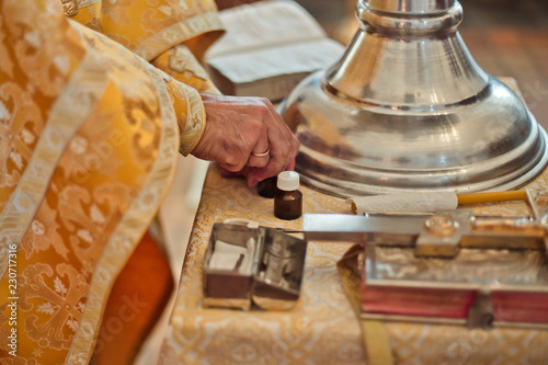 Open the Gospel and large cross on the throne of the Orthodox church in baptism. Orthodox priest laid his hands on throne