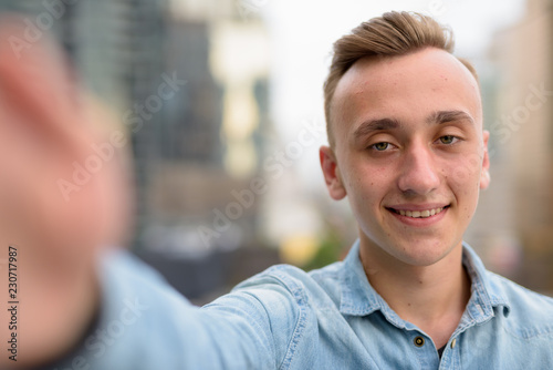 Personal point of view of happy man taking selfie with phone