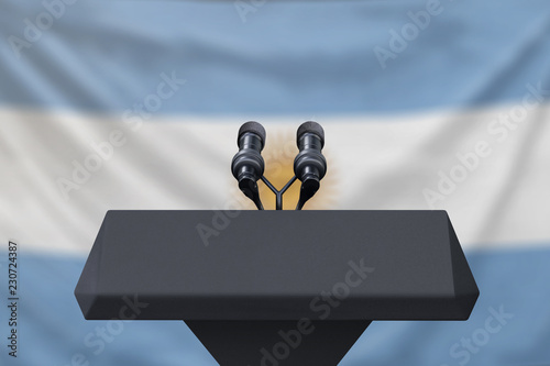 Φωτογραφία Podium lectern with two microphones and Argentina flag in background
