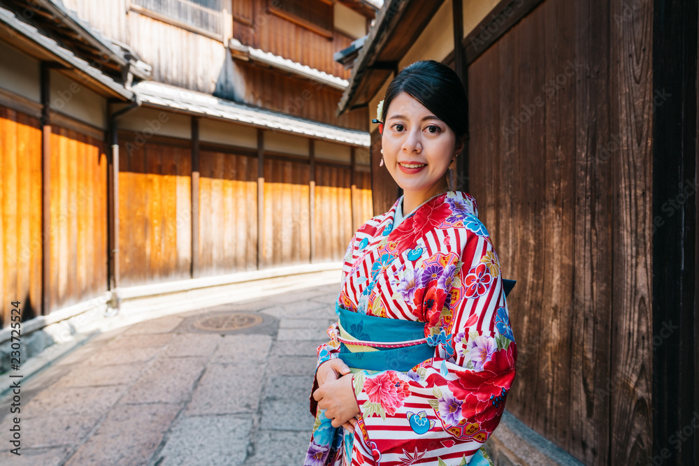 lady with kimono standing in old street