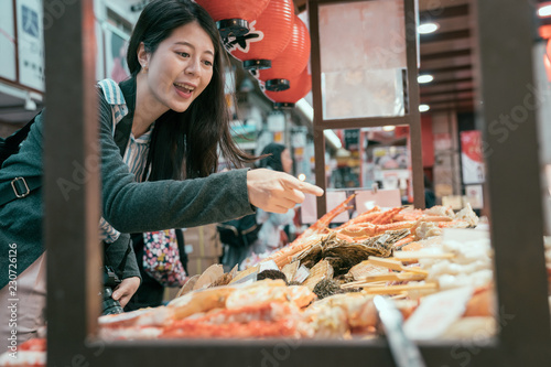 young traveler hungrily buying street food. photo