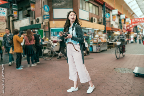 local people in kuromon market riding bicycle. photo