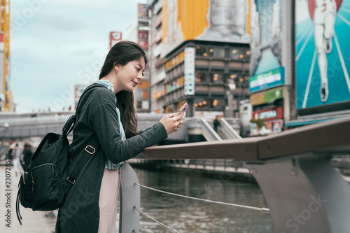 lady traveler using cellphone texting sms message photo