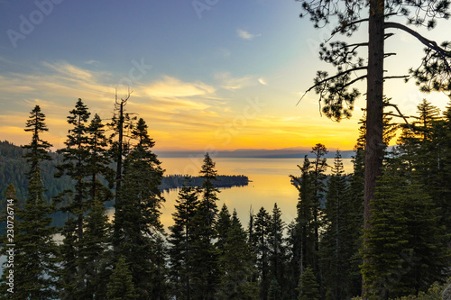 Sunrise coming over the mountains in the distance at a lookout point at Lake Tahoe