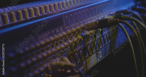 A technician works with a Mixing console photo