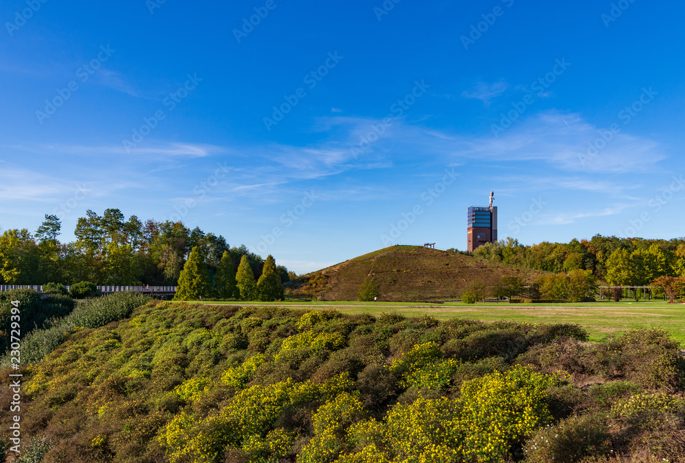 Scenery of Nordstern park, former coal mine area, consisted of various tree, small hill and background of Nordsternturm and  Zeche Nordstern.