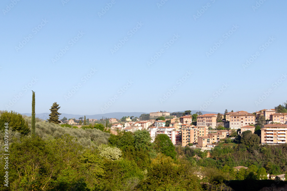Village in the Tuscan countryside as seen from Siena, Italy, located in Tuscany 