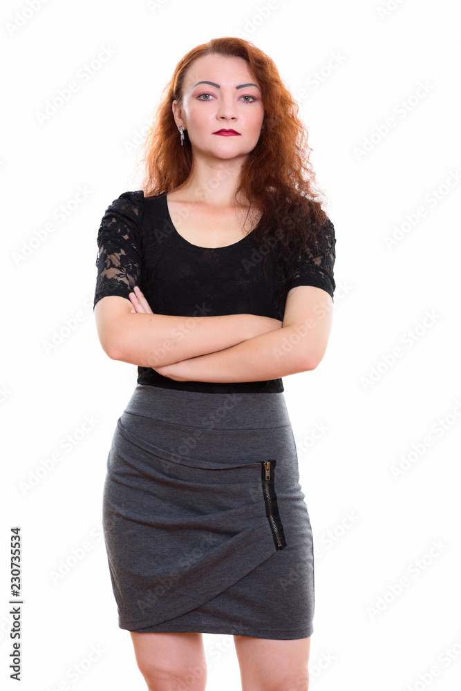 Studio shot of businesswoman standing with arms crossed Studio shot of businesswoman standing with arms crossed