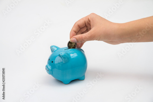 Hand of woman with piggy bank isolated white background photo