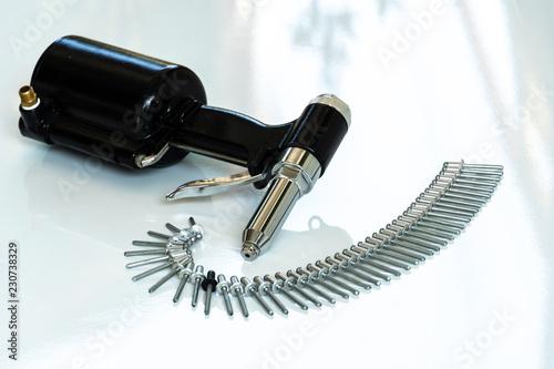 Rivet Gun and Rivets , Pneumatic rivet gun and Pop rivets on a white background.