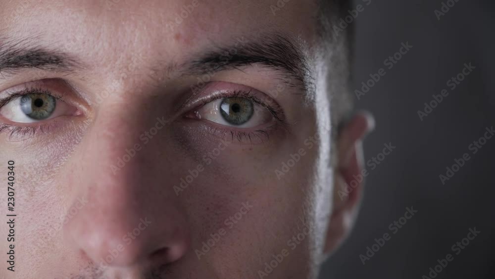 Closeup portrait of young stylish man at gray background Closeup portrait of young stylish man at gray background
