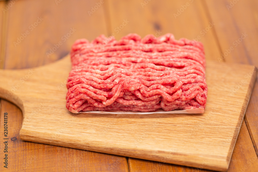 Portion of Minced Meat on an wooden table Portion of Minced Meat on an wooden table