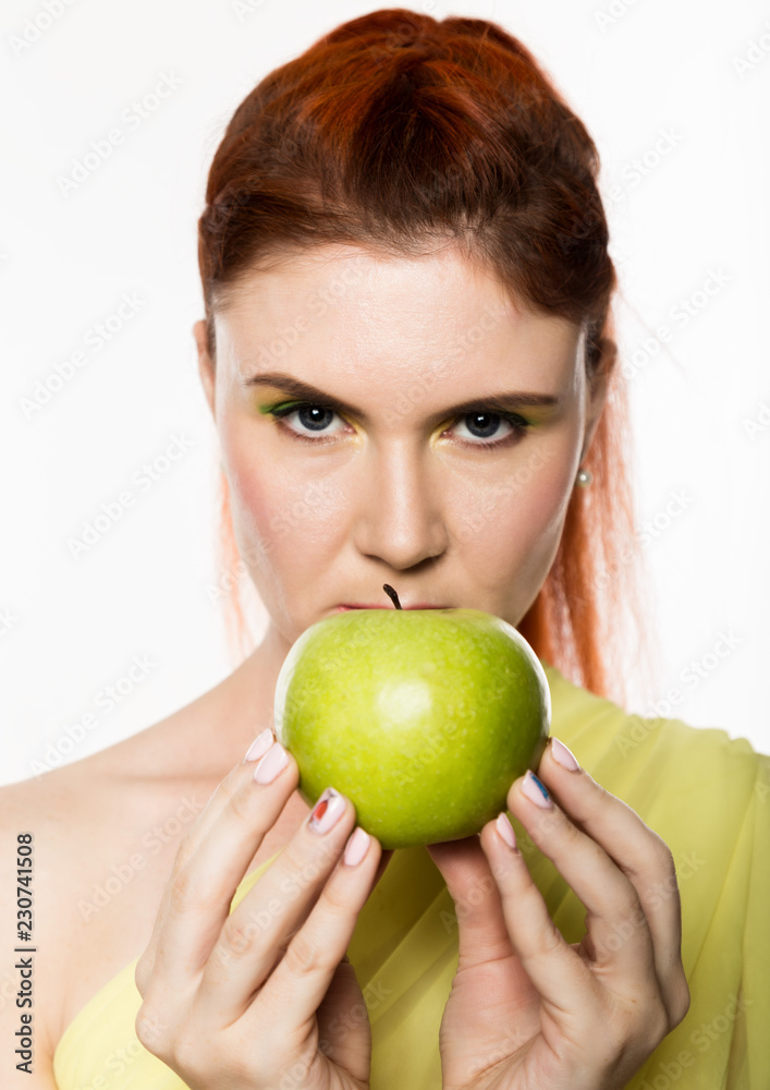 funny redhead woman holding green apple. healthy lifestyle concept funny redhead woman holding green apple. healthy lifestyle concept