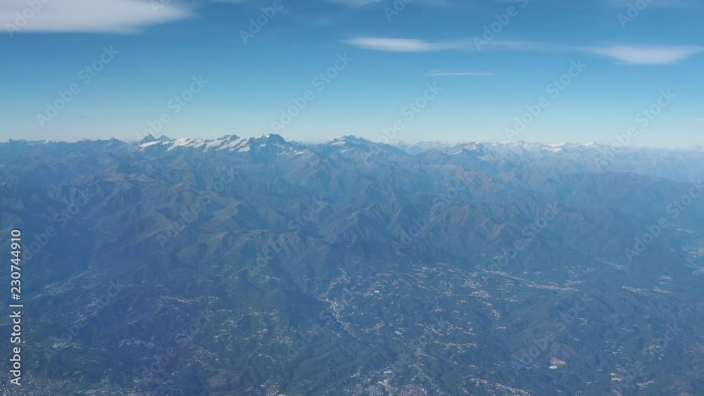 Flying over the European Alps during fall season. Aerial view from the airplane window Flying over the European Alps during fall season. Aerial view from the airplane window