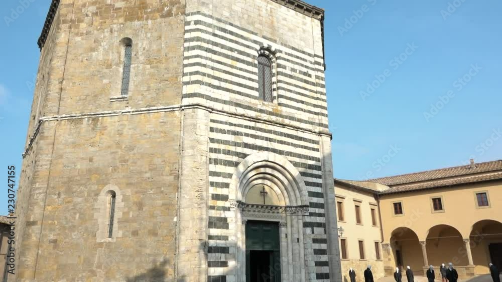 Tilt of ancient baptistery of San Giovanni, Volterra, Tuscany, Italy. Beautiful old religious building with stripes facade 11th century Romanic style. Italian holiday, sightseeing, tourism destination Tilt of ancient baptistery of San Giovanni, Volterra, Tuscany, Italy. Beautiful old religious building with stripes facade 11th century Romanic style. Italian holiday, sightseeing, tourism destination