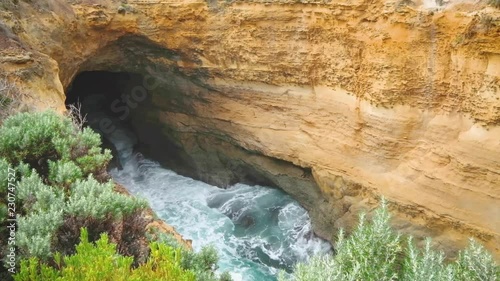 Rapidly fluctuating water level travels through the ocean-carved, Thunder Cave. The Blowhole on Australia's iconic Great Ocean Road.