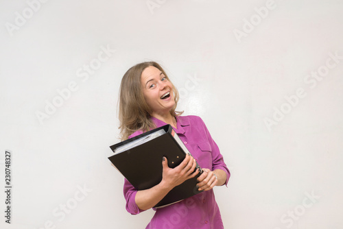 Happy girl is holding a folder with documents