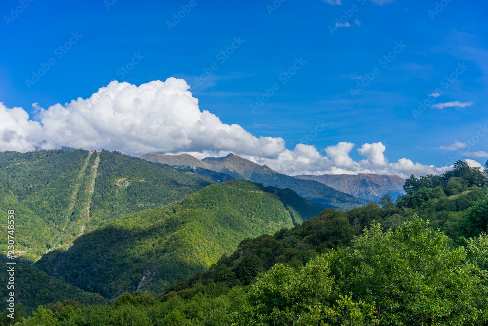 Obraz premium Mountain landscape against cloudy blue sky in Krasnaya Polyana Sochi