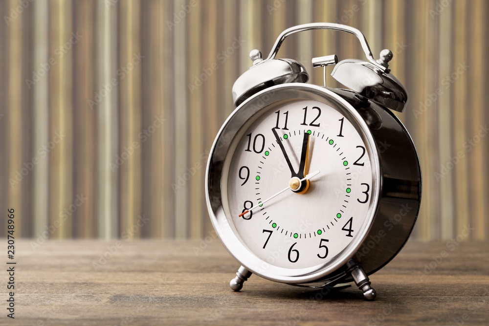 Retro alarm clock on table background Retro alarm clock on table background