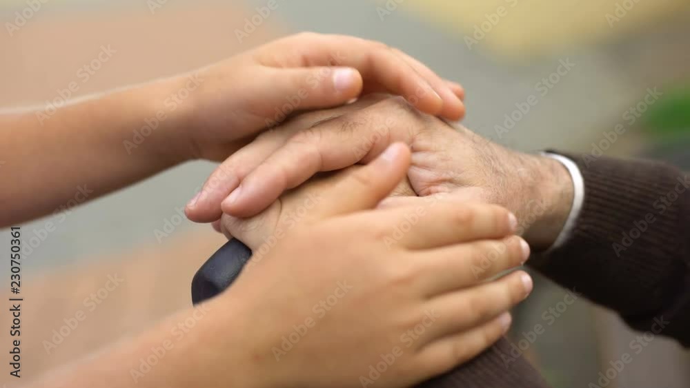 Kid stroking old man hands, social support program for pensioners, kindness Kid stroking old man hands, social support program for pensioners, kindness