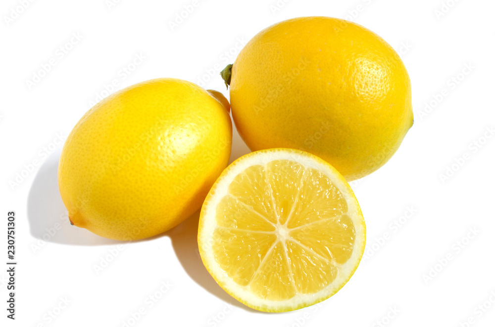 two bright yellow lemons and half lemon on white isolate background