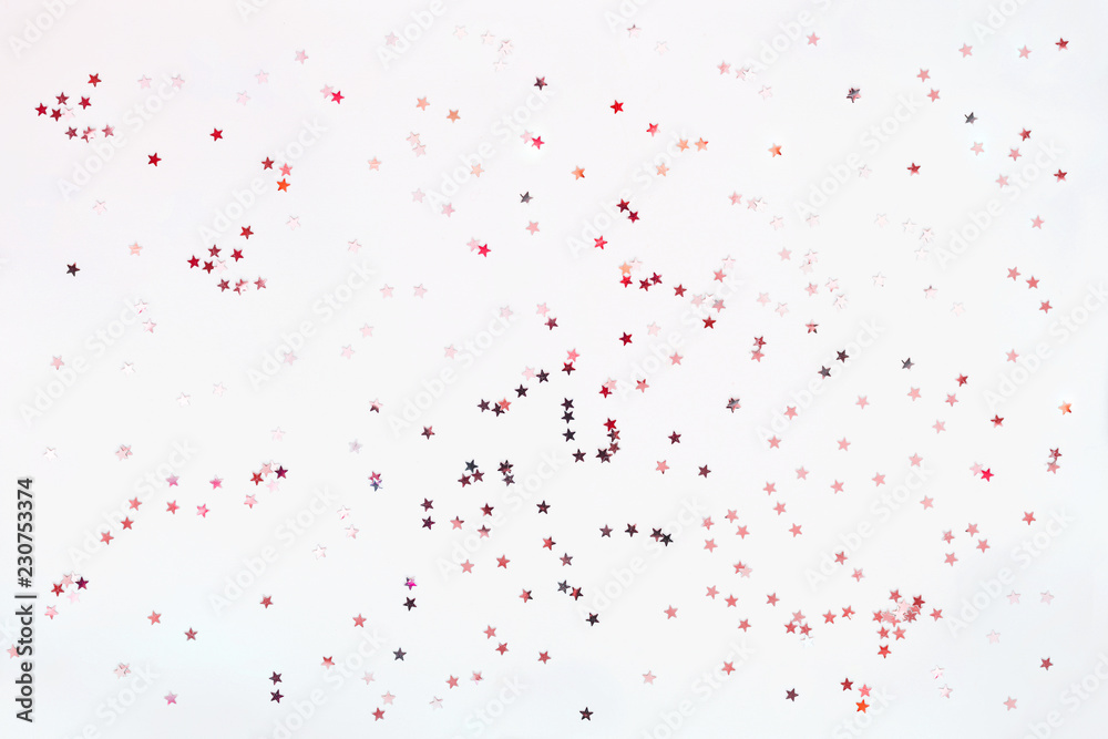 Holiday background with silver and pink star confetti. Good background for Christmas and New Year cards.