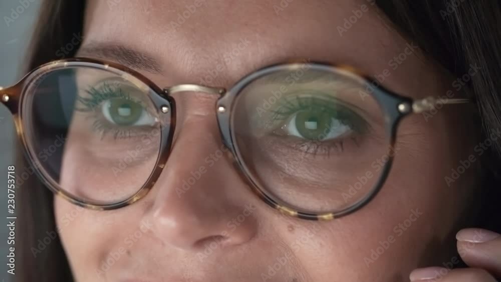 Close-up of young Caucasian woman in eyeglasses speaking on mobile phone Close-up of young Caucasian woman in eyeglasses speaking on mobile phone