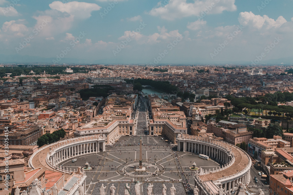 Saint Peters Square in the Vatican and an aerial view of the rooftops of Rome, Italy in a travel and tourism concept