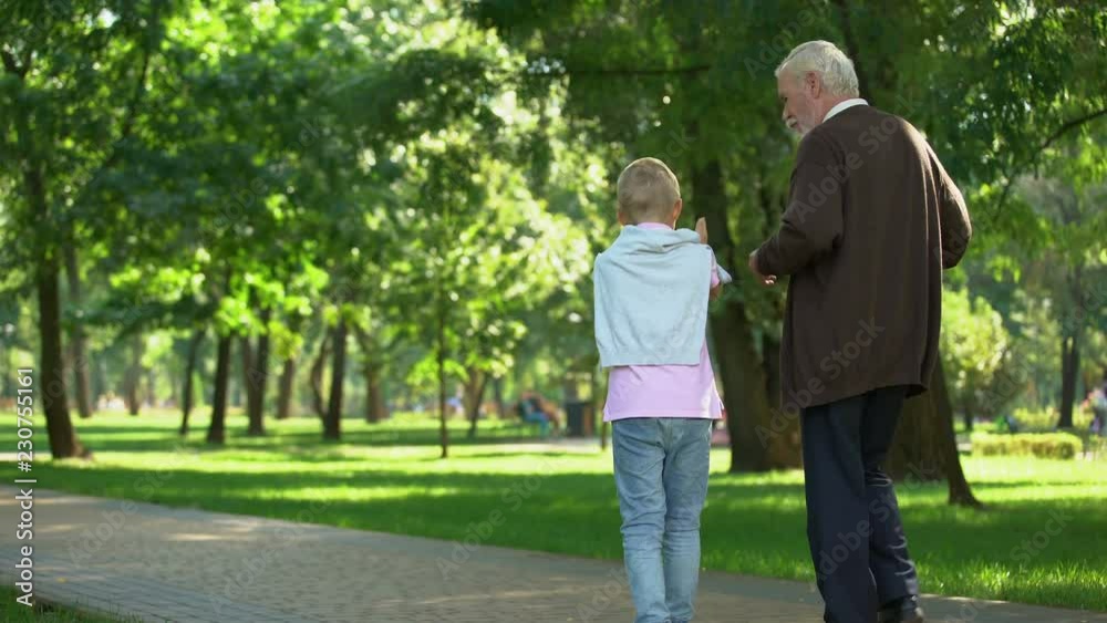Granddad walking with grandson, shares experience, education of new generation Granddad walking with grandson, shares experience, education of new generation