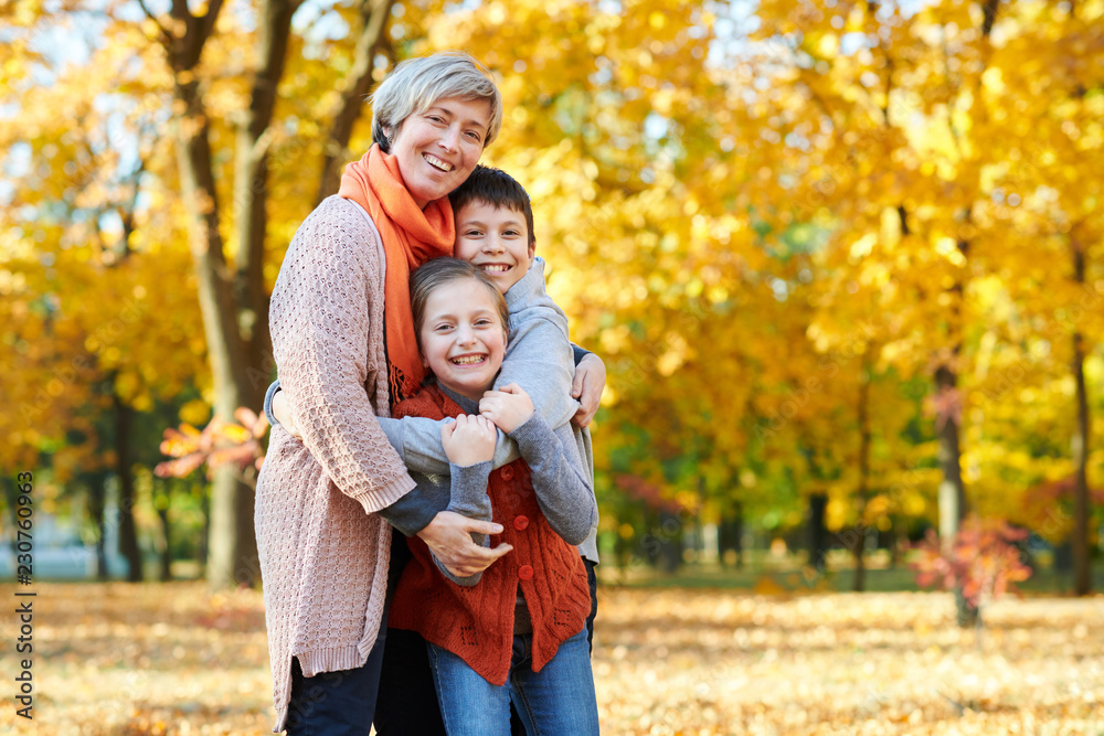 Happy family walks in autumn city park. Children and parents posing, smiling, playing and having fun. Bright yellow trees. Happy family walks in autumn city park. Children and parents posing, smiling, playing and having fun. Bright yellow trees.