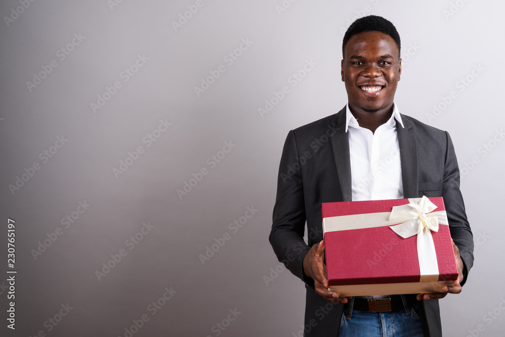 Young African businessman wearing suit against white background Young African businessman wearing suit against white background