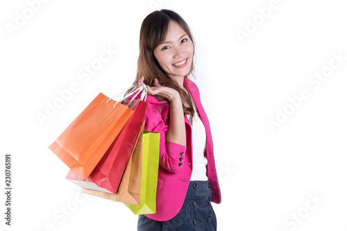 Colorful shopping vibes. Portraits of smiling Asian woman in Trendy clothes with a lot of shopping bags isolated on white.
