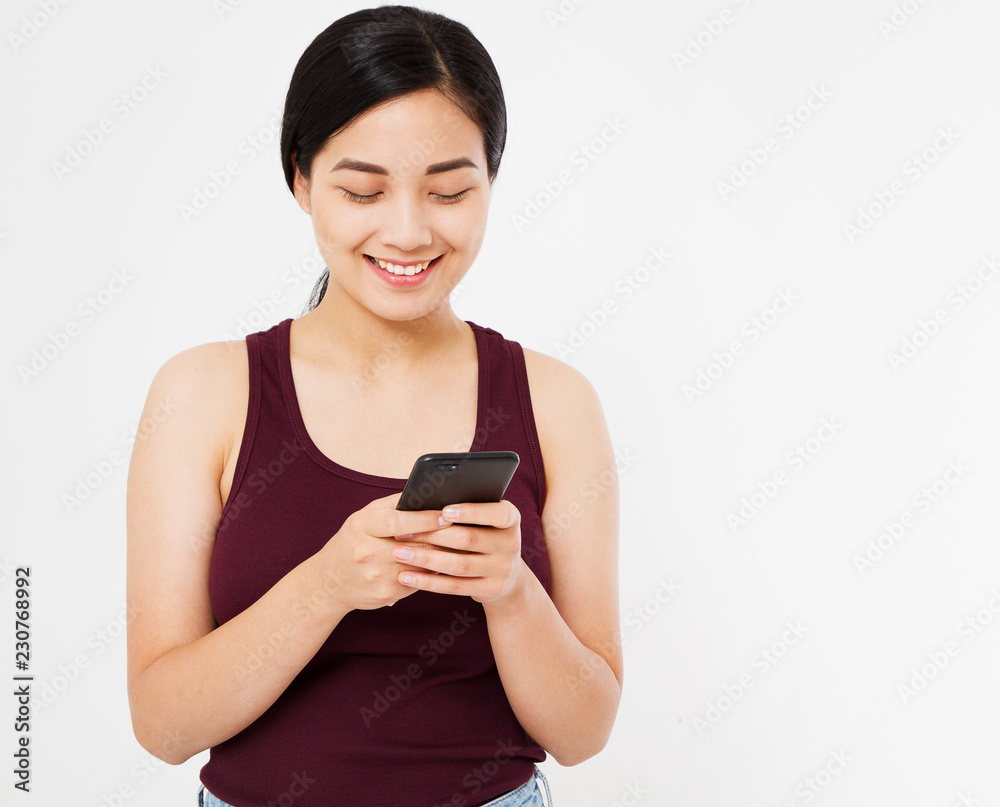 smile happy chinese girl,woman reading a pleasant message on phone isolated on white background