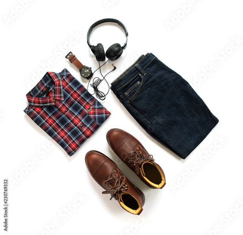 Fashionable concept, men’s clothes set with brown boot, shirt, jeans, watch and earphone isolated on white background. top view