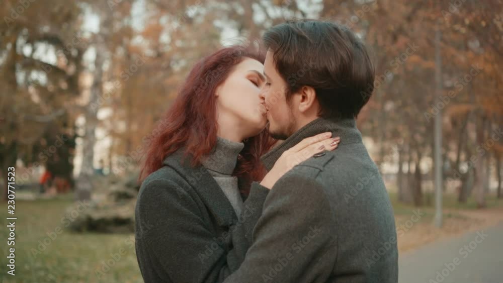 Young happy couple hugging against the background of autumn trees. Young happy couple hugging against the background of autumn trees.