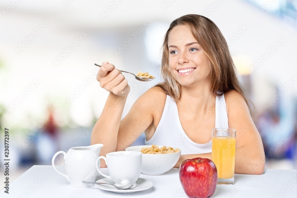 Attracive young woman enjoying tea and fruits on breakfast Attracive young woman enjoying tea and fruits on breakfast