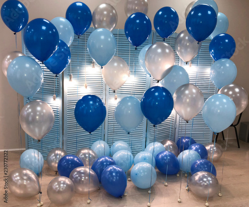 A beautiful room decorated with helium balloons of blue, light blue and silvery colors. Professional design. photo