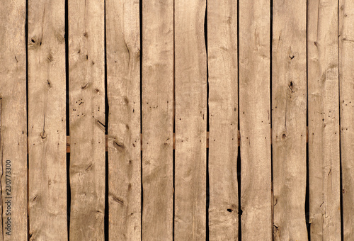 Backround. A vertical arrangement of old boards in a wooden farm building.