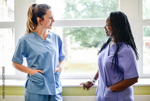 Nurses having a conversation in the hospital hallway photo