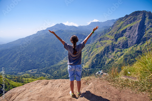 girl enjoys life at the top of the mountain in Ella, Sri Lanka
