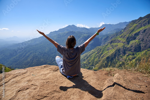 girl enjoys life at the top of the mountain in Ella, Sri Lanka