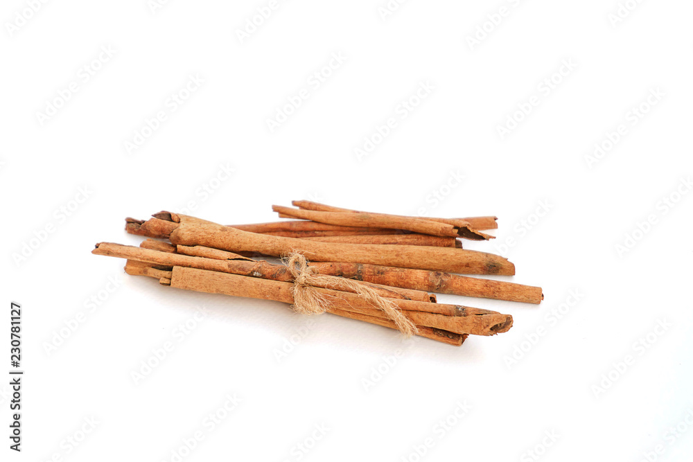 Cinnamon on a white background, light brown cinnamon on a white