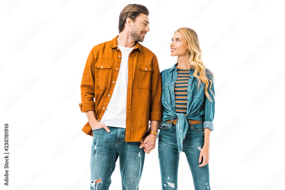 smiling young couple holding hands of each other isolated on white smiling young couple holding hands of each other isolated on white