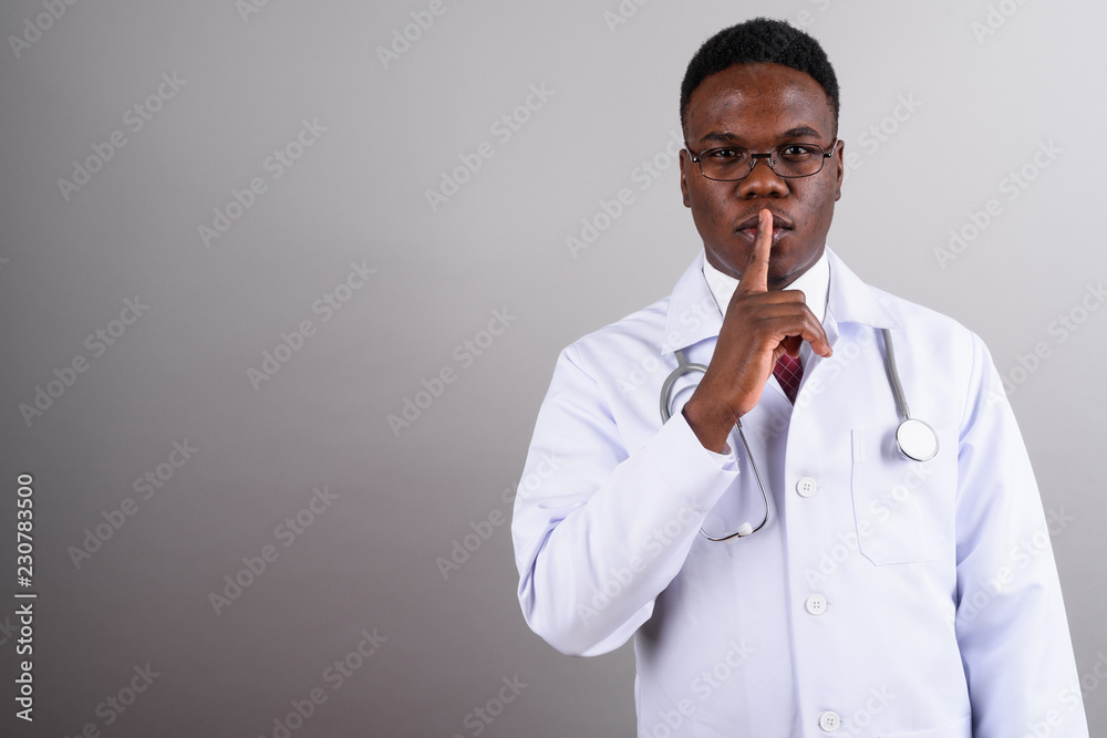 Young African man doctor against white background Young African man doctor against white background