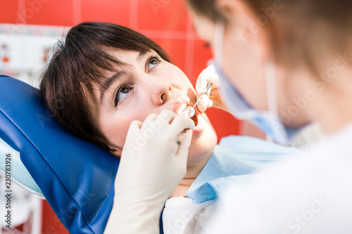 Dentist treats dental caries close-up