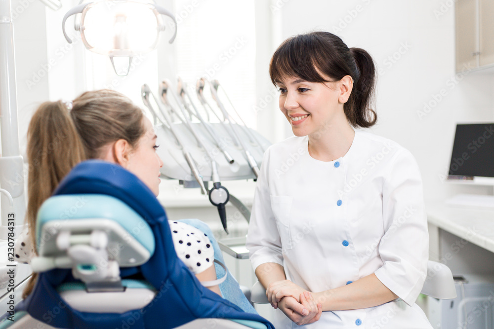 Dentist advises the patient at the clinic Dentist advises the patient at the clinic