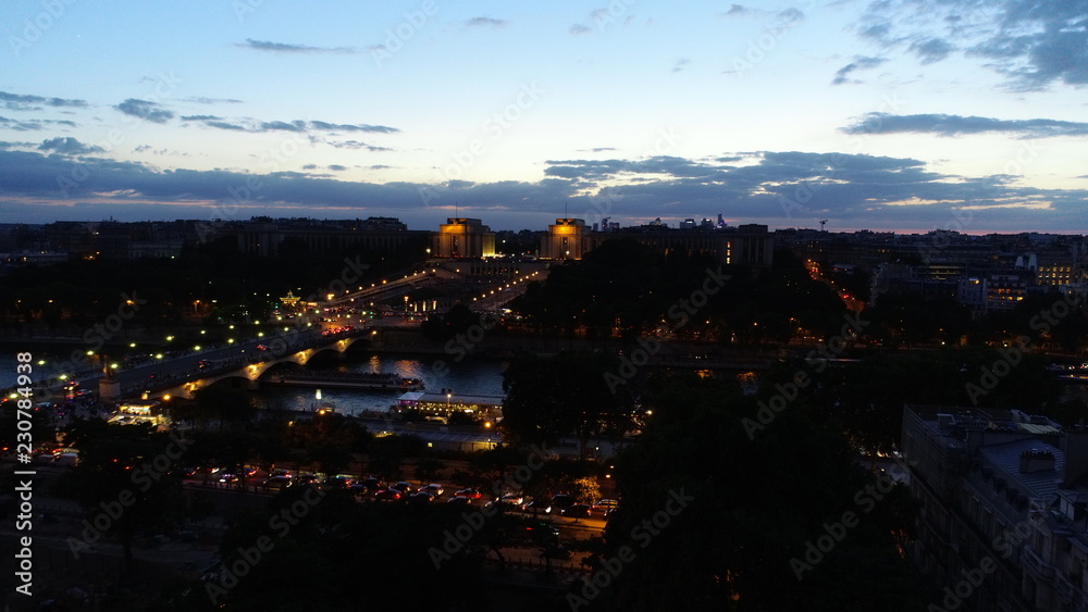 aerial paris eiffel tower france summer nigh in the city on evening and blue sky in backgound
