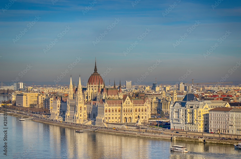 Parliament building on the east bank of the Danube, Budapest, Hungary. Winter landscape on a sunny day.