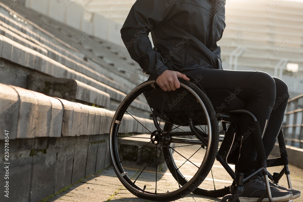 Disabled athletic moving with wheelchair at sports venue Disabled athletic moving with wheelchair at sports venue