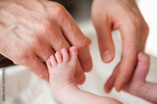 father's hands and baby's feet © Anna Lurye